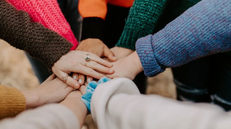 Several hands placed on top of each other