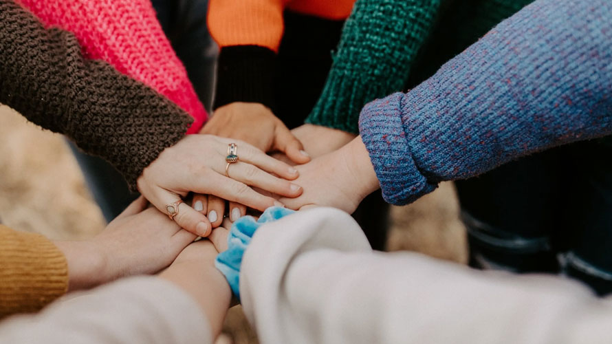 Several hands placed on top of each other