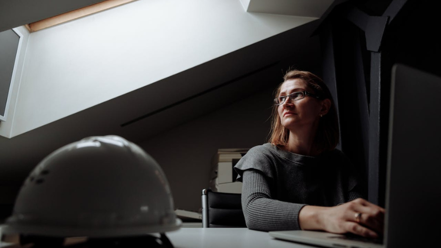 Woman sitting alone at work carrying an invisible workload at work